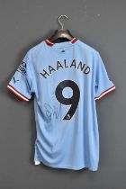 ERLING HAALAND; a Manchester City Treble Winners football shirt, signed to the reverse, size M.