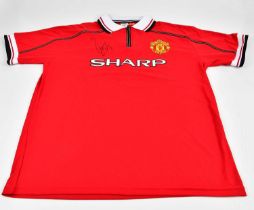 MANCHESTER UNITED; an offical retro football shirt signed by Paul Scholes, sold with certificate