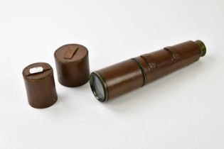 A leather cased brass two draw telescope.