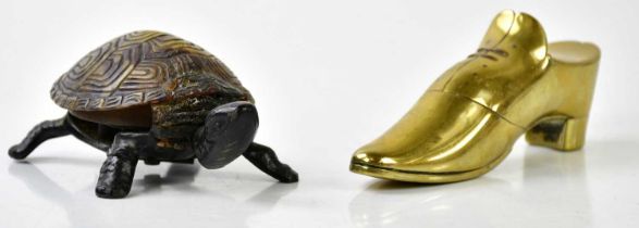 A 19th century novelty brass snuff box modelled as a shoe, length 13cm, and a black metal and faux
