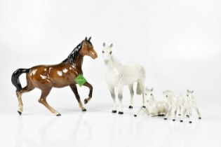 BESWICK; a model of a brown horse, a Beswick grey horse, and three Royal Doulton foals (5) Condition