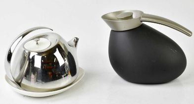 GEORG JENSEN; a boxed modern stainless steel teapot with ceramic lid and stand, also a Georg