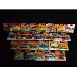 26 x Matchbox Carded Vehicles. Makers included Ford, Cadillac, Mazda, Fiat and Jaguar. Some MBX