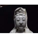 Chinese Large Blanc De Chine Dehua Style Porcelain figure of a standing Guan Yin atop Lotus flowers.