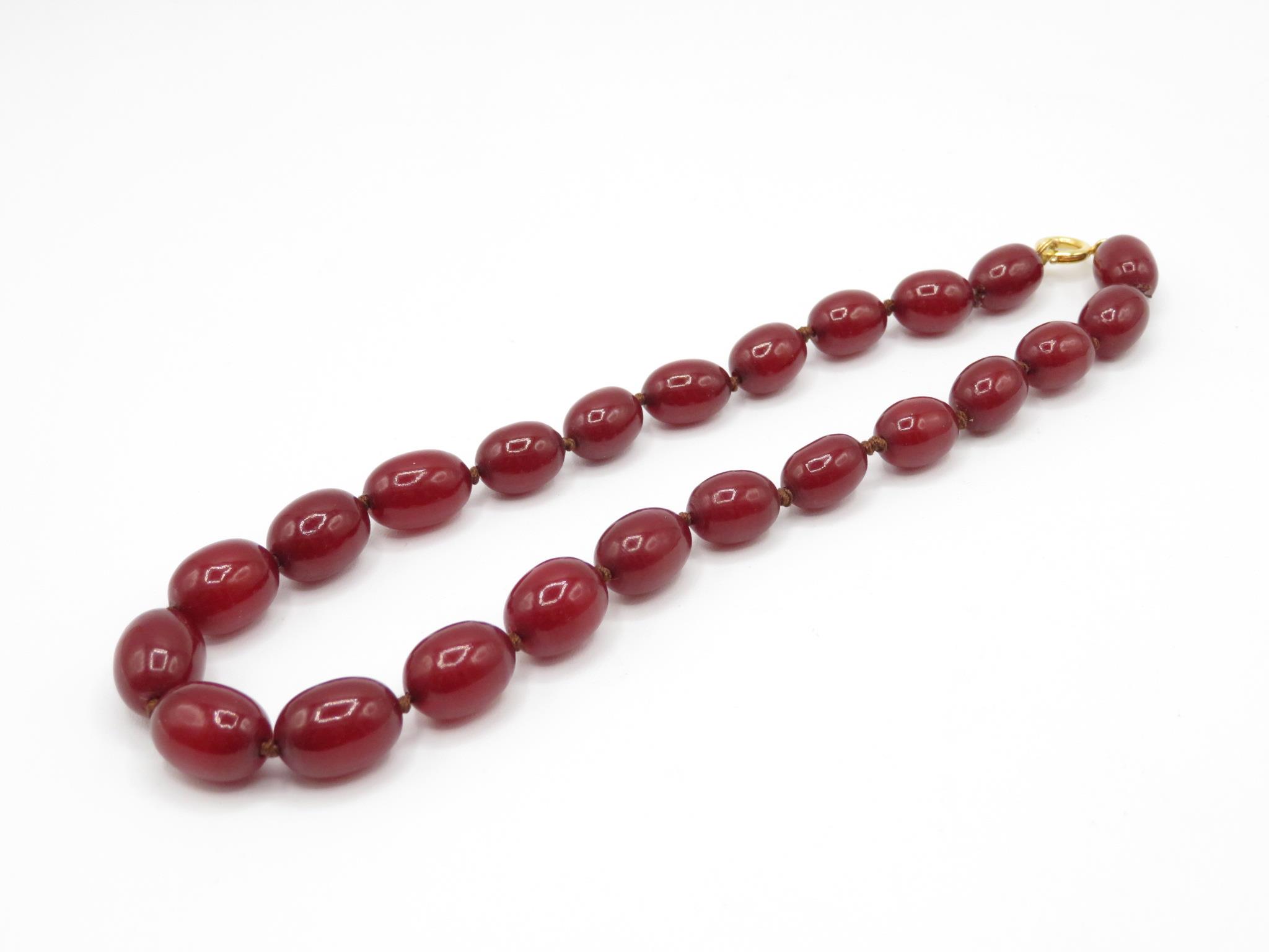 A Small Bakelite Bead Necklace With Internal Streaking