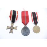 3x German WWII medals including Merit Cross, Merit Medal and Eastern Front Medal. //
