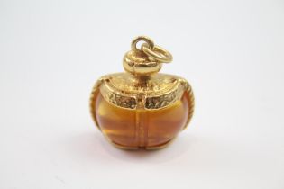 Gold tone perfume bottle design pendant by designer YSL