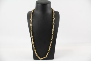 Long length gold tone necklace by designer Christian Dior