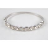 Silver gemstone bangle featuring multi cut stones (21g)