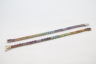Two silver multi gemstone tennis bracelets including Topaz (25g)