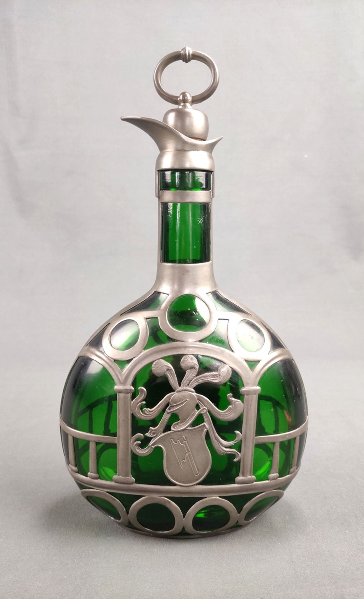 Bottle with decorative pewter frame, green glass, with cork stopper, on one side decorated with kni