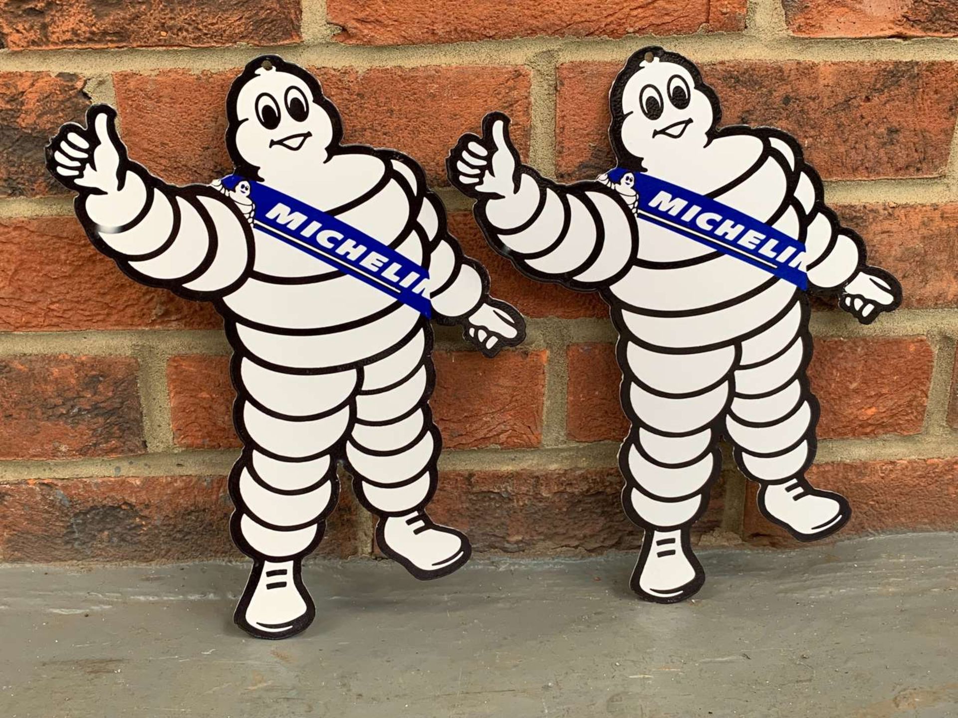Two Metal Small Michelin Men Signs