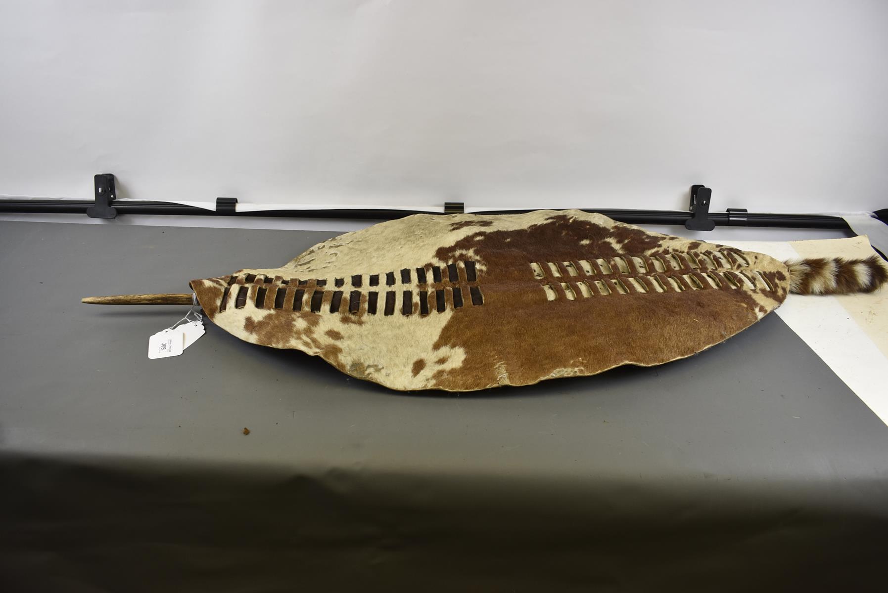 A ZULU HIDE SHIELD, the oval cattle hide shield with rectangular slit decoration to the front with - Image 2 of 8