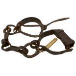 A SET OF EARLY 19TH CENTURY IRON PRISONER'S LEG SHACKLES, 51cm long approx. Bears what appears to be