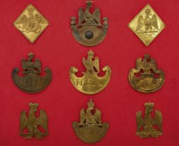 IMPERIAL FRENCH SHAKO PLATES. A mounted display of nine very fine items including two 'diamond'
