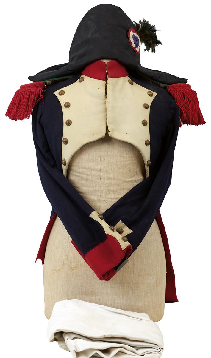 A FRENCH FIREMAN'S FULL DRESS COATEE. Navy blue cloth with scarlet cloth collar, cuffs and turn
