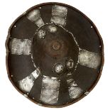 A 19TH CENTURY ETHIOPIAN HIDE SHIELD, 55cm diameter body with turned rim, profusely decorated with