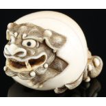 Japan 18th/19th Century, ivory Katabori-Netsuke Shishi in the ball, Meiji period,