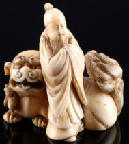 Japan 19th/20th Century, ivory Katabori-Netsuke man with shishi, Meiji period,