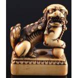 Japan 18th century, ivory netsuke shishi on base, Edo period,