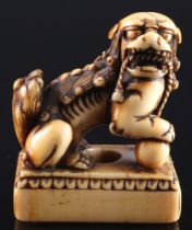 Japan 18th century, ivory netsuke shishi on base, Edo period,