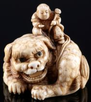 Japan 18th/19th Century, ivory signed netsuke shishi with ball, Edo period,