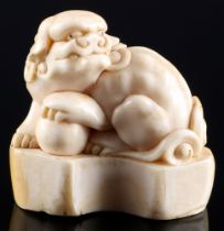 Japan 18th/19th Century, ivory netsuke shishi on base, Edo period,