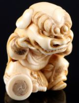 Japan 19th/20th Century, ivory Katabori-Netsuke boy with shishi mask, signed, Meiji period,