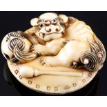 Japan 19th century, ivory Manju-Netsuke Shishi with temple bell, Meiji period,