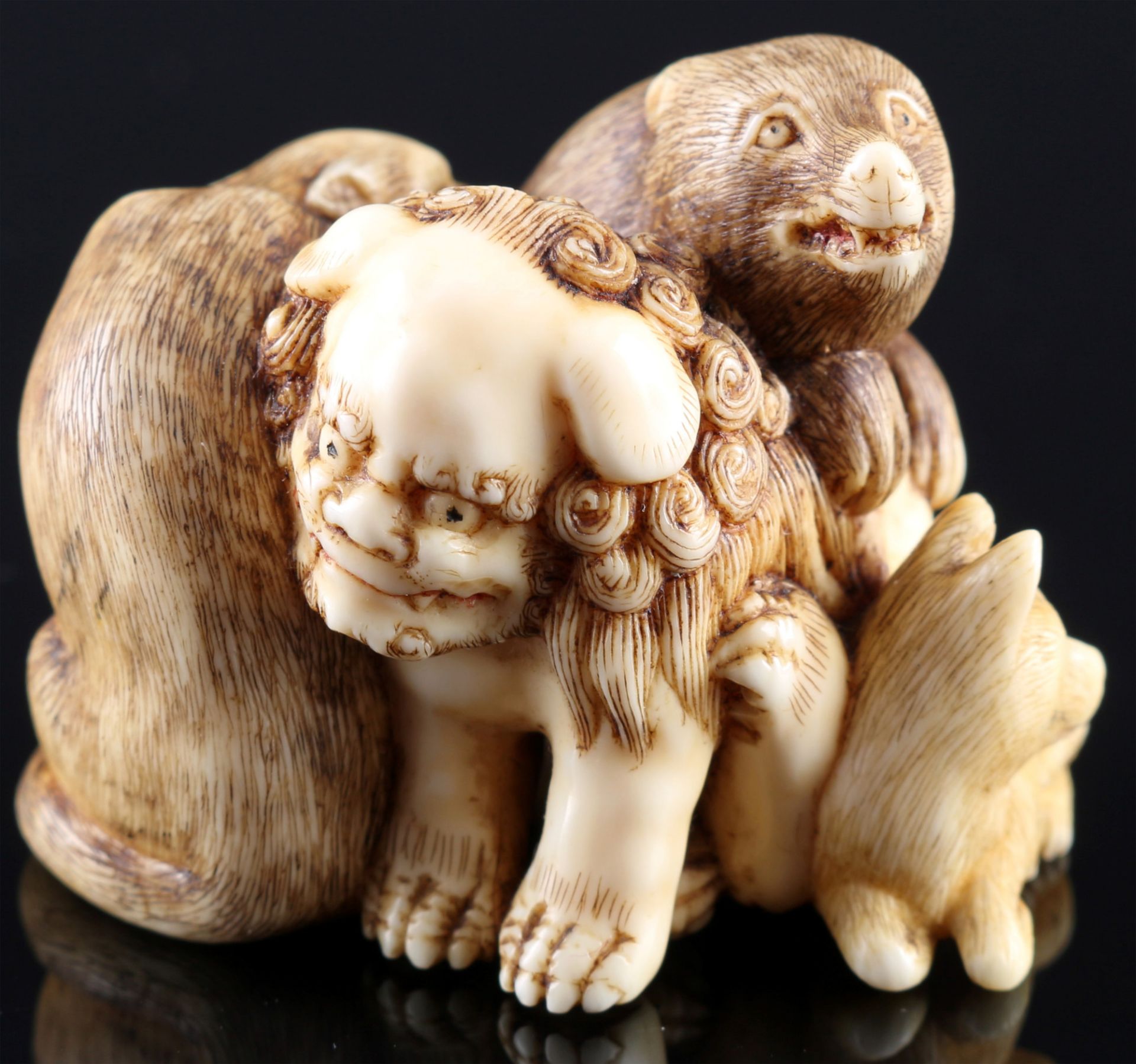 Japan 18th century, ivory Katabori-Netsuke Shishi with animals, signed,Edo period,