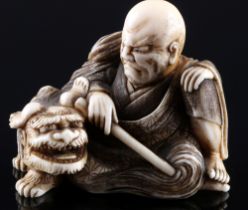 Japan 19th/20th Century, ivory Katabori-Netsuke man with shishi, Shungetsu, signed, Meiji period,