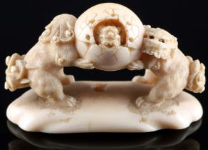 Japan 19th century, ivory netsuke shishi with ball, signed, Meiji period,