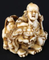 Japan 19th/20th Century, ivory Mitsujun Katabori-Netsuke man with shishi, Meiji period,