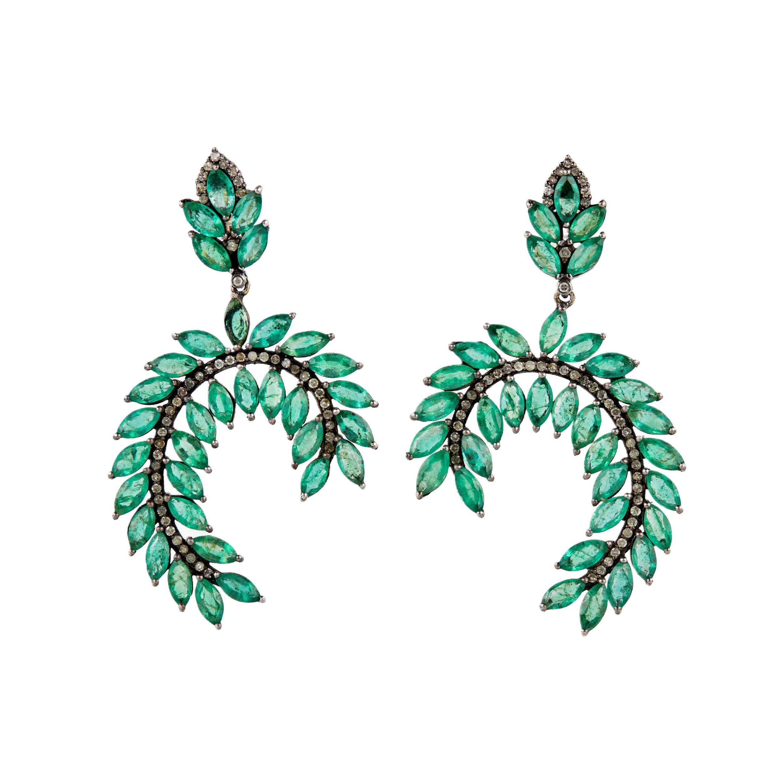 Silver earrings with emeralds and diamonds.