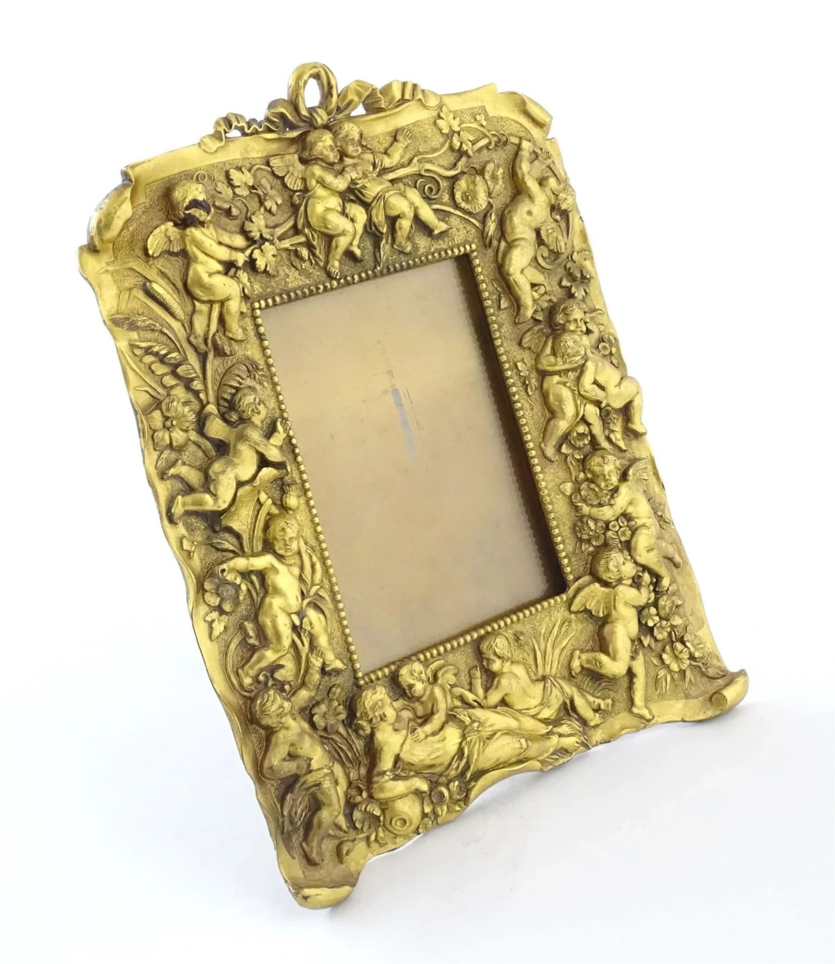 Non-trivial photo frame of gilded bronze in the Neo-Baroque style.