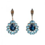 Silver earrings with topazes and diamonds.