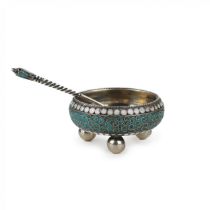 An elegant silver salt cellar with a spoon.