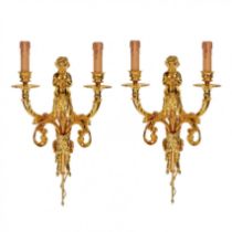 A pair of gilded sconces, with currency curls, surmounted by cherubs.