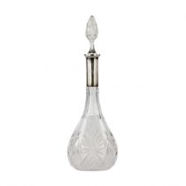 Crystal decanter with a silver neck.