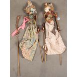 Zwei Wayang-Puppen. Indonesien. Holz, geschnitzt, bemalt, bunte Stoffkleider, H=je 90 cm.