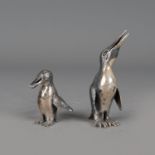 Two silver penguines