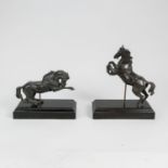 Two jumping horse sculptures