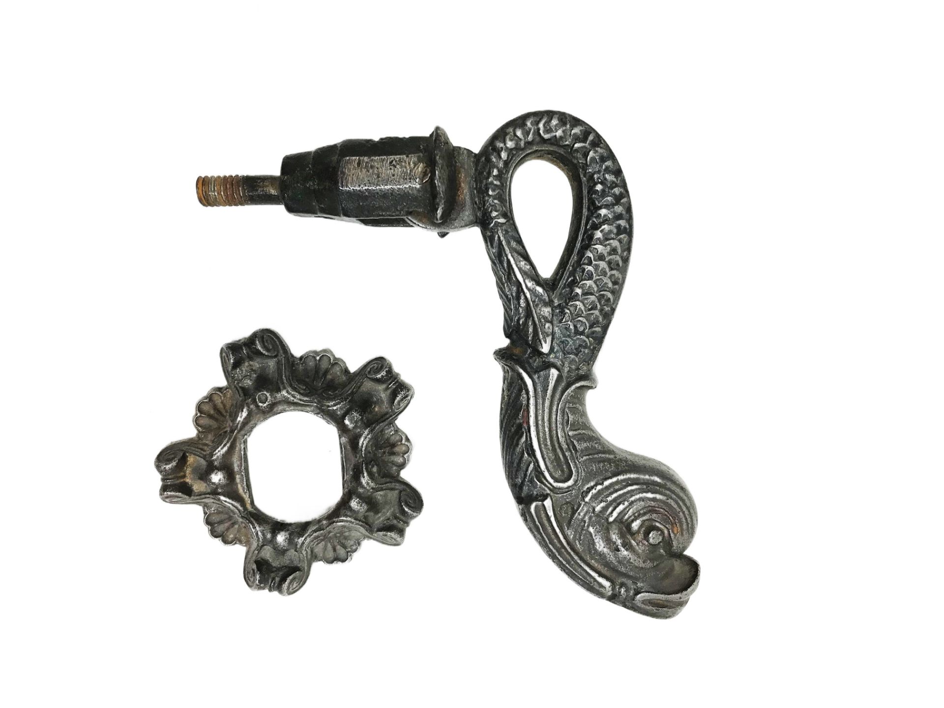 Iron door knocker with dolphin on leafy rose. 18.6 cm. Part of the chapter "From the Time of the