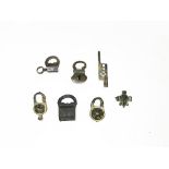 Six padlocks, two iron and four bronze and a lock bolt. H: 4, 48 cm - 3, 53 cm - 4, 96 cm - 5, 18 cm