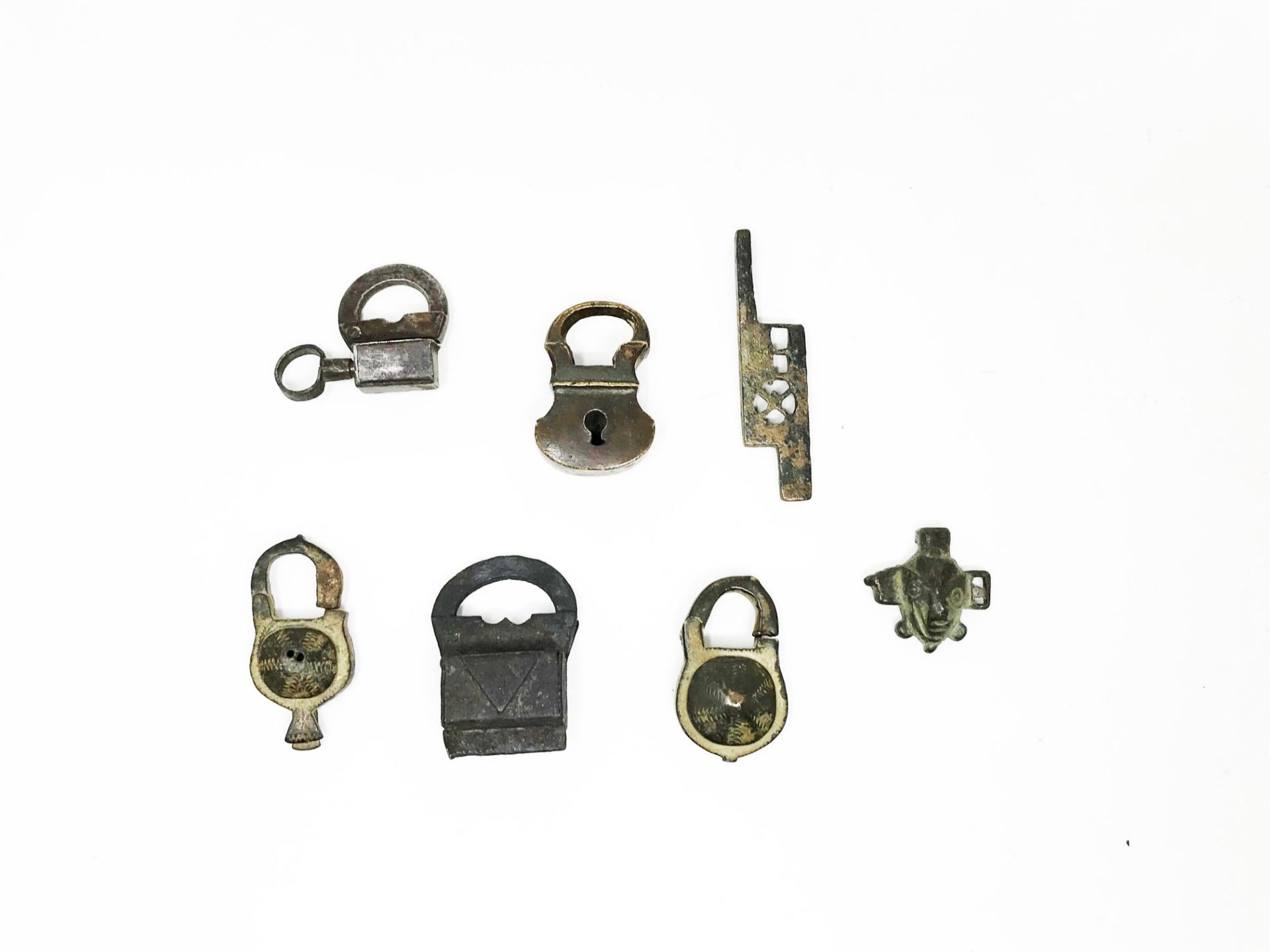 Six padlocks, two iron and four bronze and a lock bolt. H: 4, 48 cm - 3, 53 cm - 4, 96 cm - 5, 18 cm