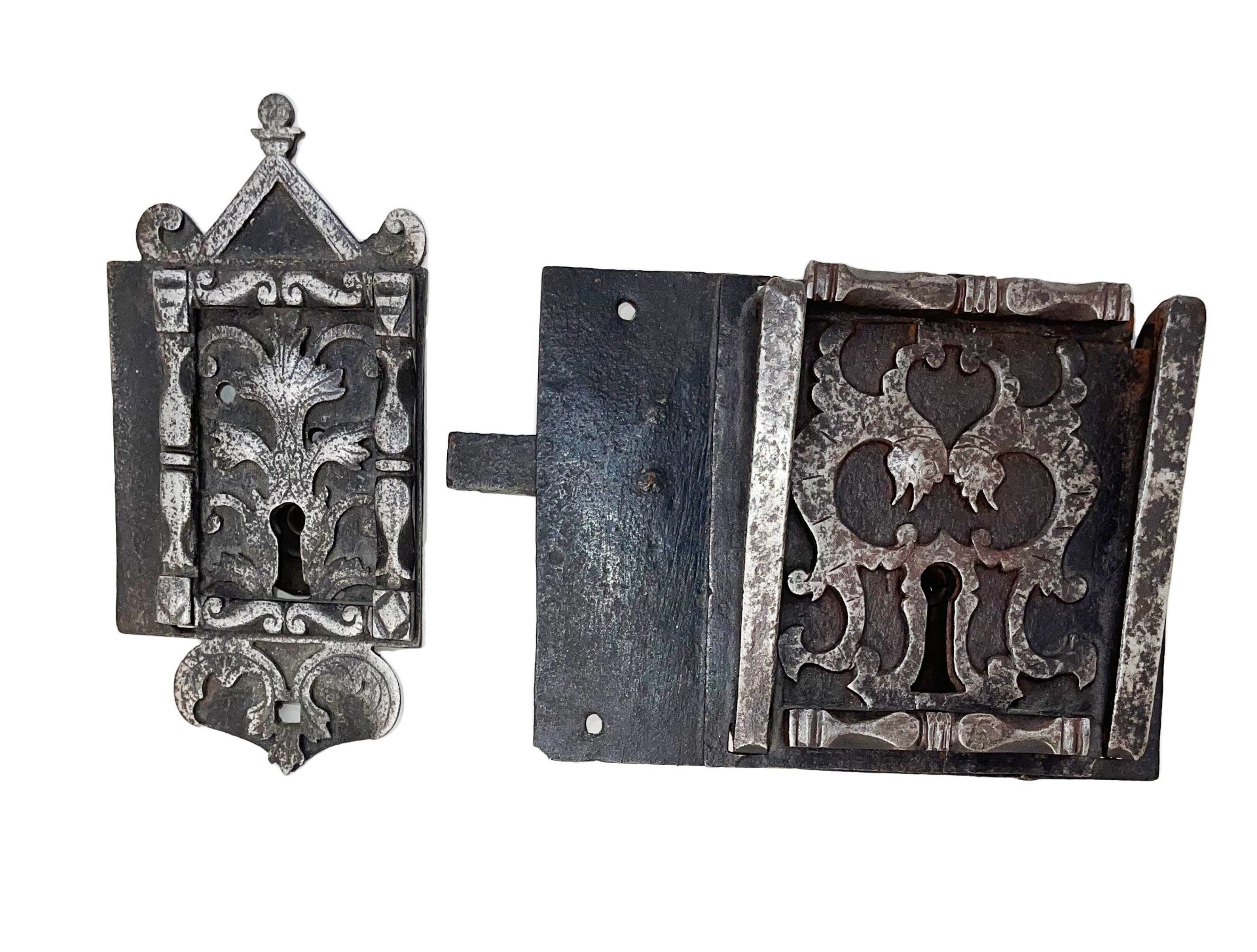 Two locks of the same construction:- one, crowned by a capital and supported by foliage scrolls, two