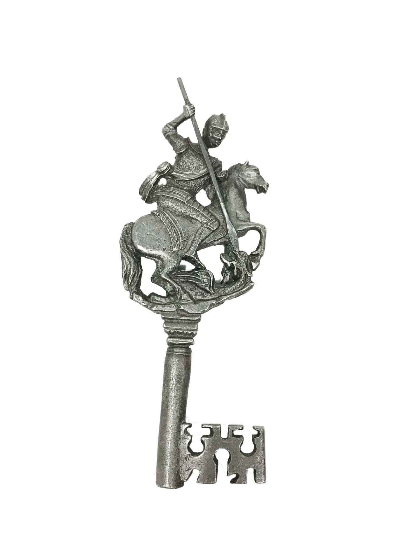 Cast metal gothic style key, decorated with Saint Michael slaying the dragon.14, 83 cm. Part of