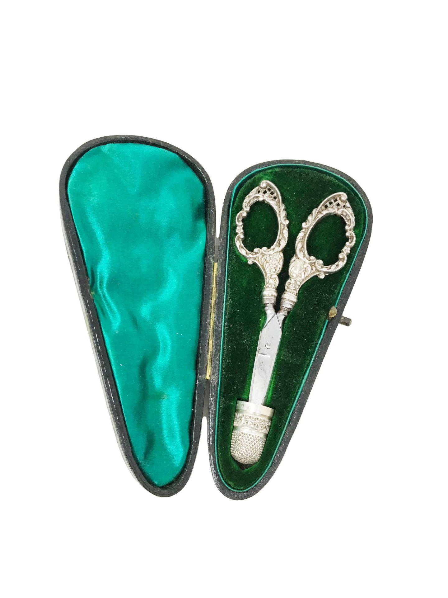 Sewing case covered with black leather on the outside and green satin on the inside, with scissor