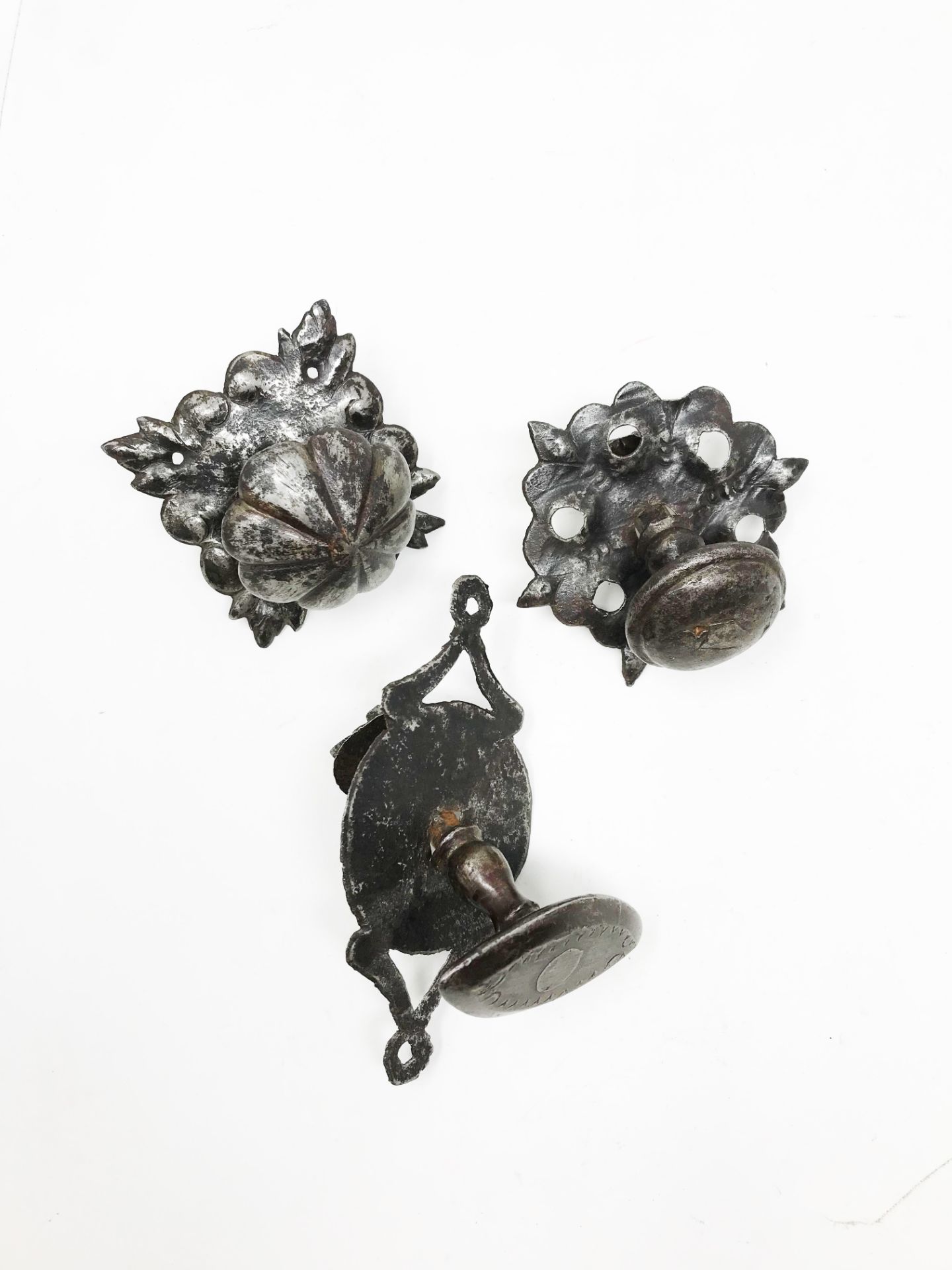 Three wrought iron pull handles on plate18.4 - 21.9 - 16.8 cm. Part of the chapter "From the Time of