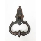 Wrought and carved iron knocker with two masks. The bulbs of the twisted ring engraved with